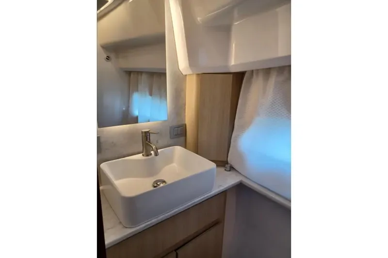Slide: The Image of Modern bathroom sink in 2023 Regal 42 FXO yacht, featuring sleek design and elegant fixtures. - 27