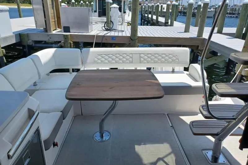 Slide: The Image of Luxurious seating area on 2023 Regal 42 FXO yacht with elegant wooden table. - 12