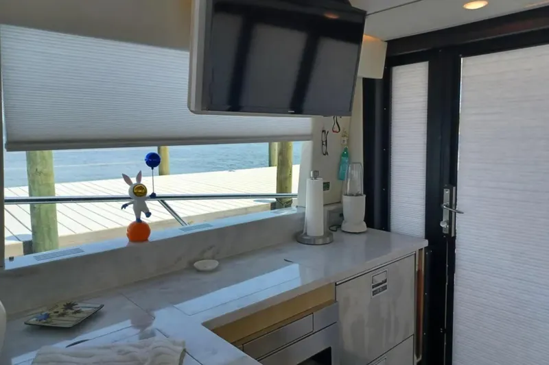 Slide: The Image of Interior of 2023 Regal 42 FXO yacht with modern kitchen and waterfront view. - 21