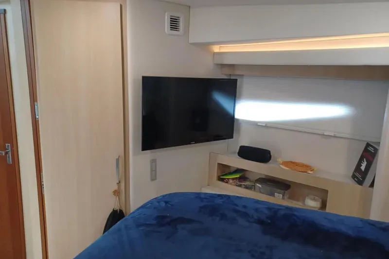 Slide: The Image of Interior of 2023 Regal 42 FXO yacht with TV and storage shelves. - 29
