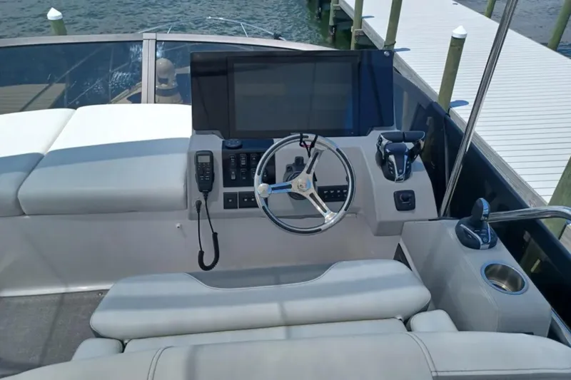 Slide: The Image of Helm of 2023 Regal 42 FXO yacht with modern controls and steering wheel. - 17