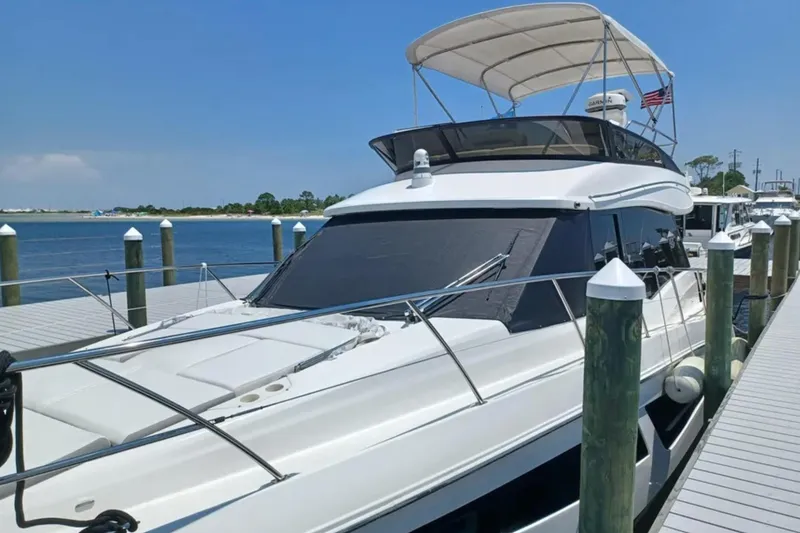 Slide: The Image of 2023 Regal 42 FXO yacht docked at marina, featuring sleek design and spacious deck. - 6