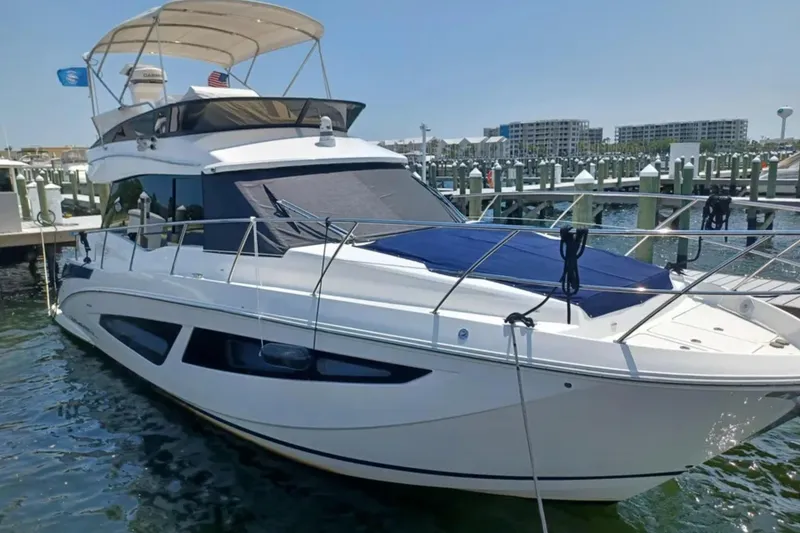 The Image of 2023 Regal 42 FXO yacht docked at marina under clear sky. - 0