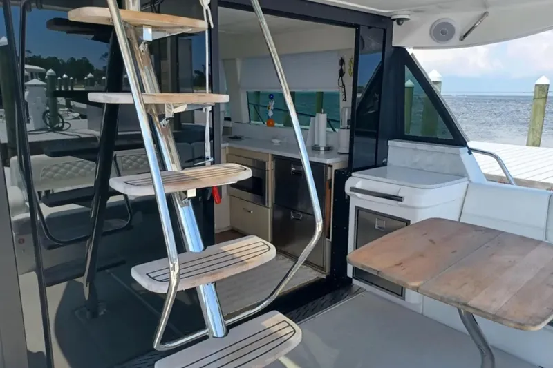 Slide: The Image of Modern interior of 2023 Regal 42 FXO yacht with sleek staircase and kitchenette. - 10