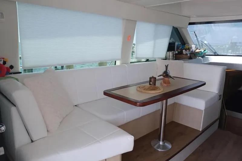 Slide: The Image of Luxurious interior of 2023 Regal 42 FXO yacht with white seating and elegant table. - 19