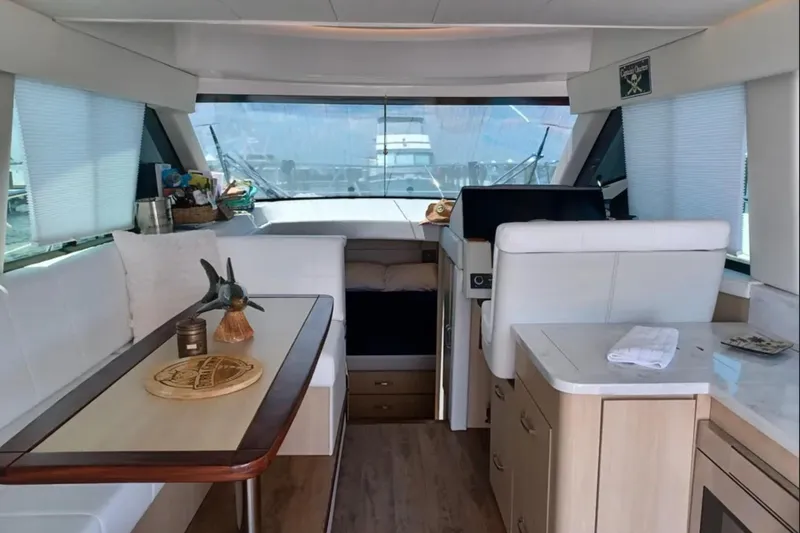 Slide: The Image of Luxurious interior of 2023 Regal 42 FXO yacht with modern furnishings and panoramic windows. - 18