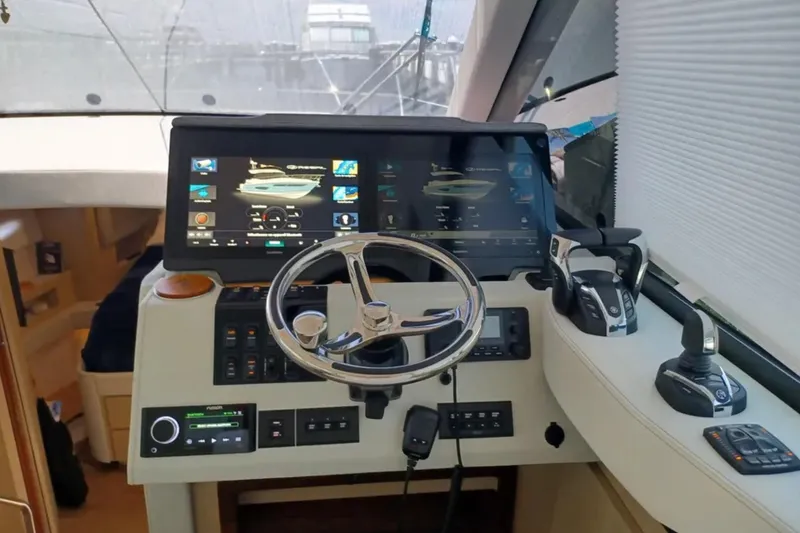 Slide: The Image of Helm of 2023 Regal 42 FXO yacht with modern controls and touchscreen displays. - 22
