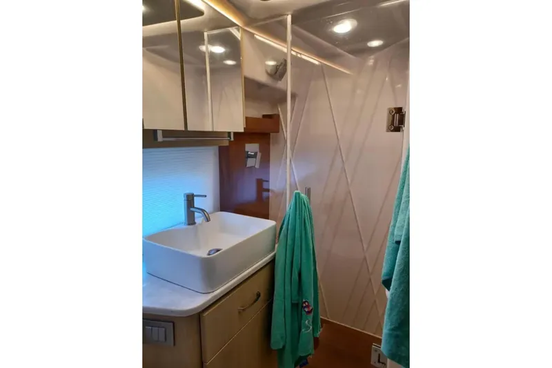 Slide: The Image of Modern bathroom interior of 2023 Regal 42 FXO yacht with sleek sink and towels. - 31