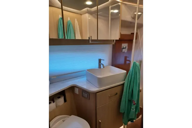 Slide: The Image of Modern bathroom interior of 2023 Regal 42 FXO yacht with sleek sink and cabinetry. - 26