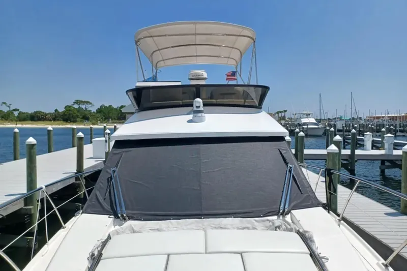 Slide: The Image of 2023 Regal 42 FXO yacht docked at marina under clear blue sky. - 8