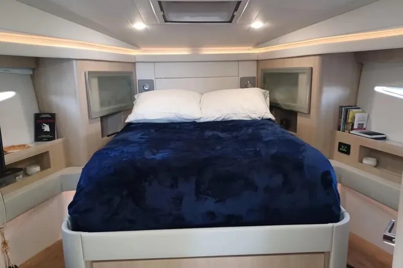 Slide: The Image of Luxurious cabin interior of 2023 Regal 42 FXO yacht with cozy bed and modern amenities. - 24