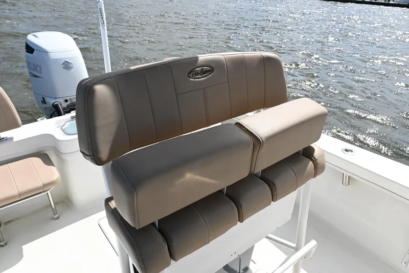 Slide: The Image of 2022 Pair Customs 21 Center Console DV boat interior with cushioned seating and Suzuki engine. - 13