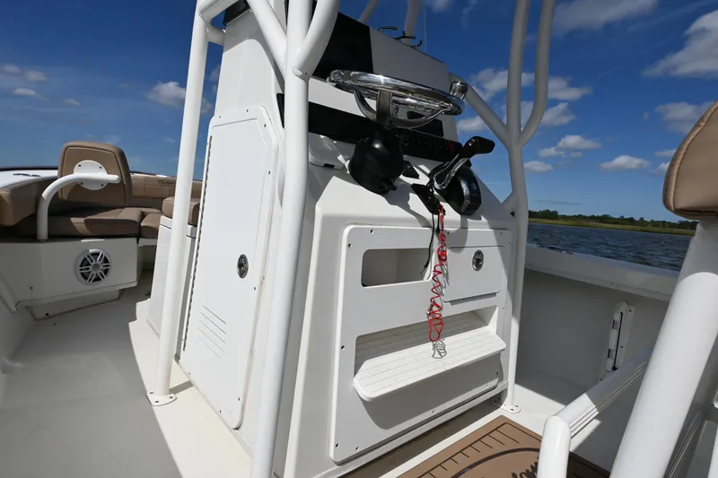 Slide: The Image of 2022 Pair Customs 21 Center Console DV boat interior with steering console and seating. - 16