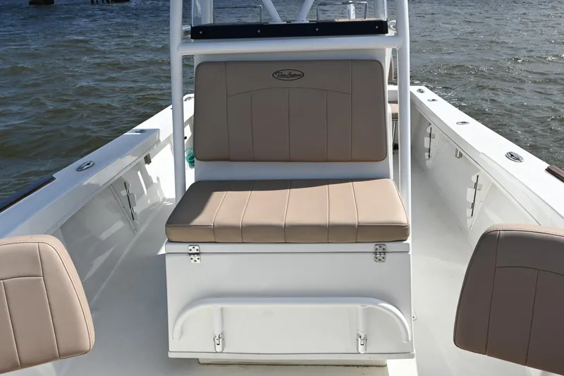 Slide: The Image of 2022 Pair Customs 21 Center Console DV boat interior with tan seating on water. - 17
