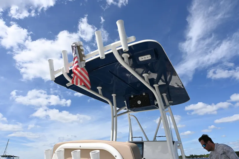 Slide: The Image of 2022 Pair Customs 21 Center Console DV boat with T-top and American flag under blue sky. - 20
