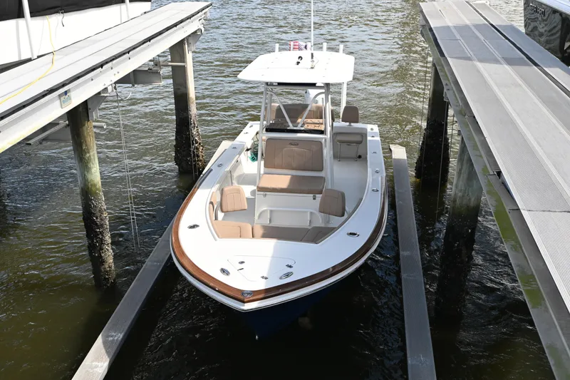 Slide: The Image of 2022 Pair Customs 21 Center Console DV boat docked in marina. - 21