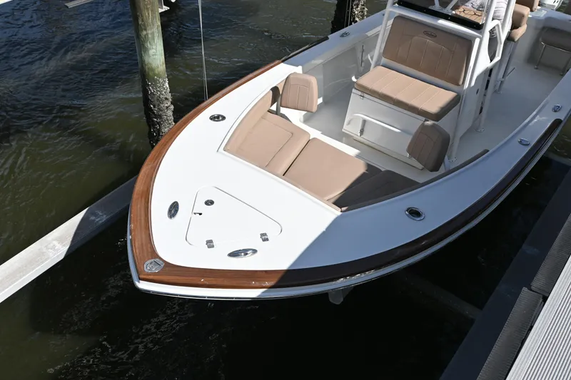 Slide: The Image of 2022 Pair Customs 21 Center Console DV boat with tan seating, docked in water. - 22