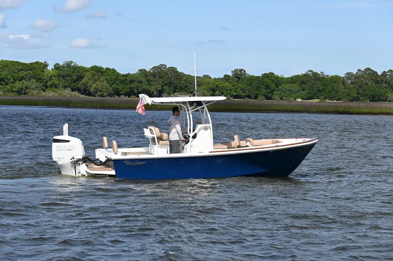 Slide: The Image of 2022 Pair Customs 21 Center Console DV boat cruising on a scenic river. - 3