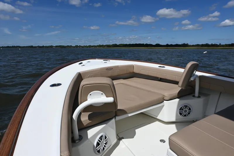 Slide: The Image of 2022 Pair Customs 21 Center Console DV boat on calm water, featuring comfortable seating. - 8