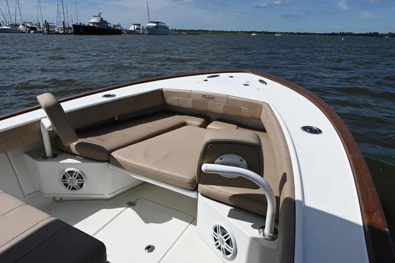 Slide: The Image of 2022 Pair Customs 21 Center Console DV boat interior with tan seating on water. - 9