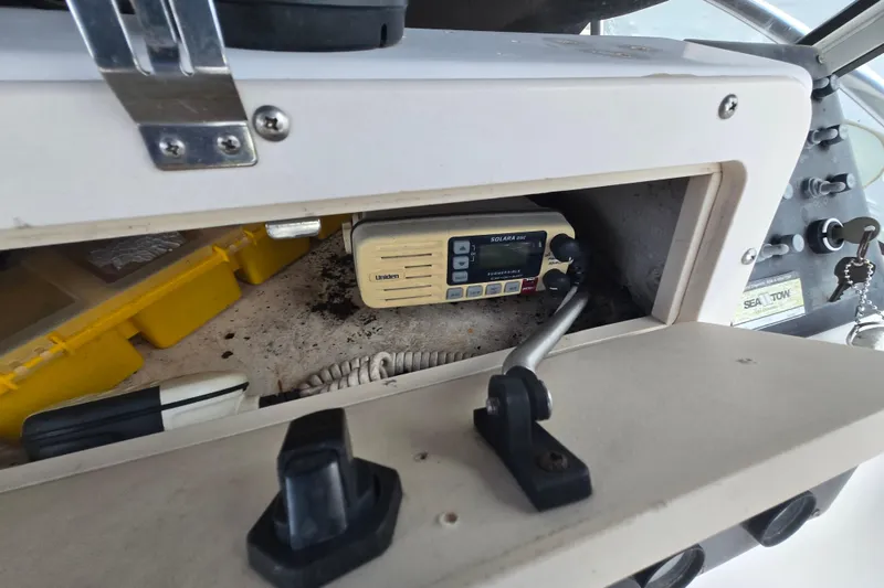 Slide: The Image of 1994 Sea Pro 190 Dual Console boat dashboard with radio and storage compartment. - 10