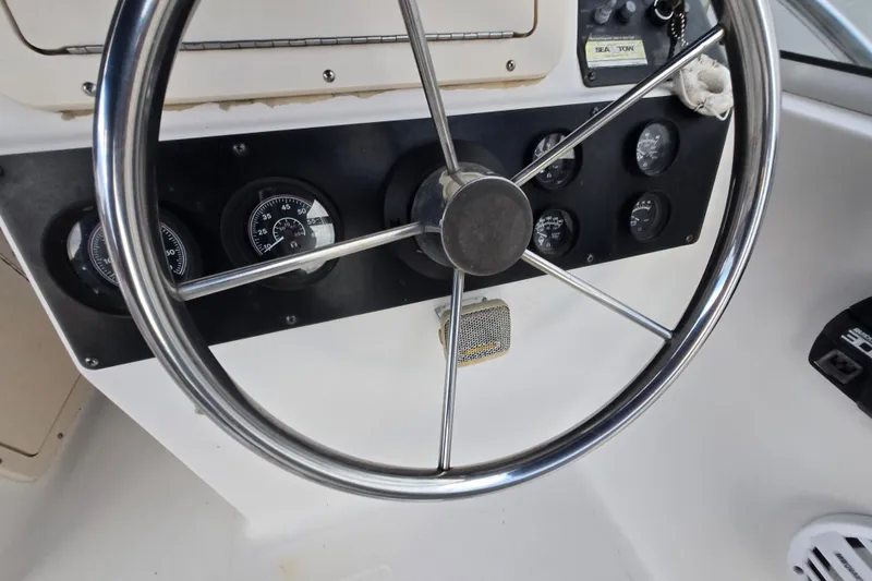 Slide: The Image of Steering wheel and dashboard of a 1994 Sea Pro 190 Dual Console boat. - 12