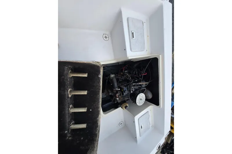 Slide: The Image of Engine compartment of a 1994 Sea Pro 190 Dual Console boat, showing internal components. - 13