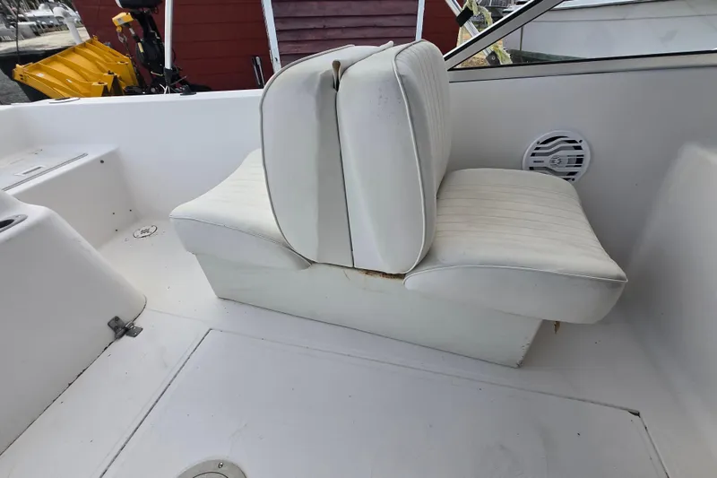 Slide: The Image of White seating on a 1994 Sea Pro 190 Dual Console boat interior. - 17