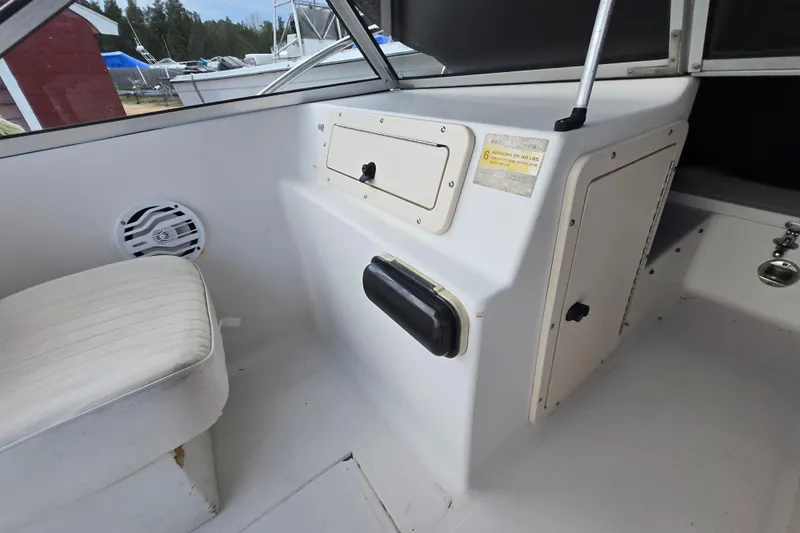 Slide: The Image of 1994 Sea Pro 190 Dual Console interior with seating and storage compartments. - 18