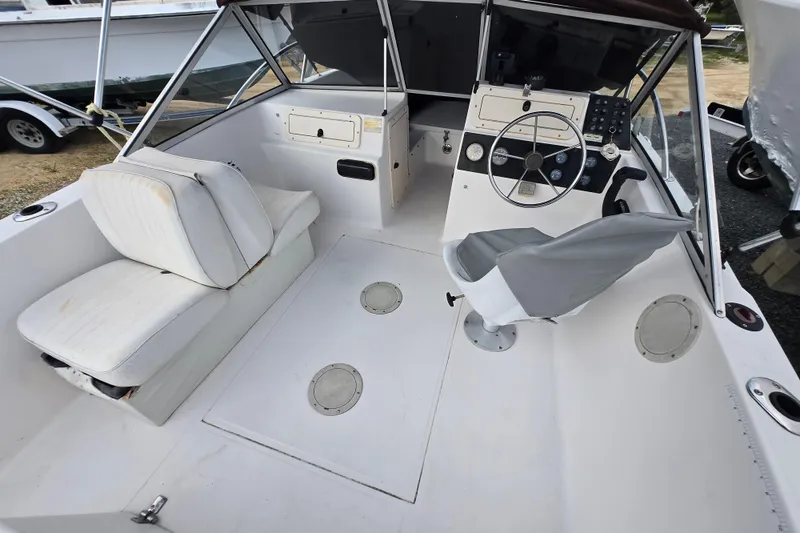 Slide: The Image of 1994 Sea Pro 190 Dual Console boat interior with steering wheel and seating. - 2