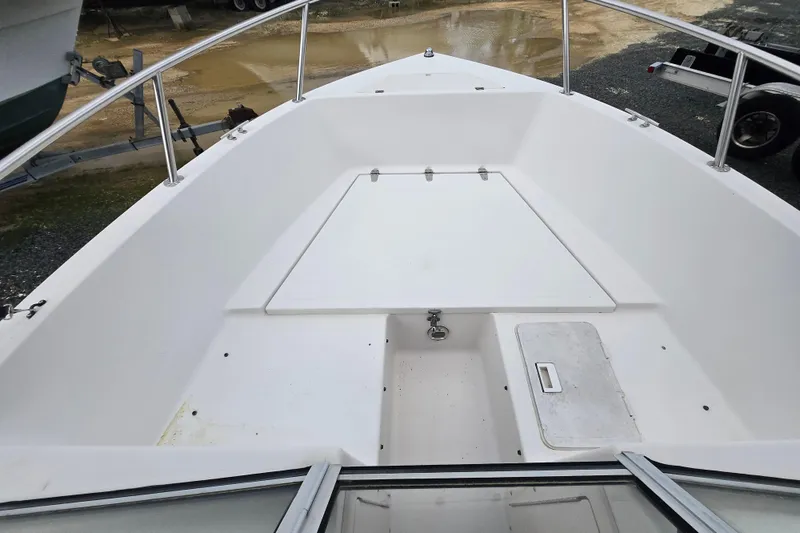Slide: The Image of 1994 Sea Pro 190 Dual Console boat interior with storage compartments and railing. - 7