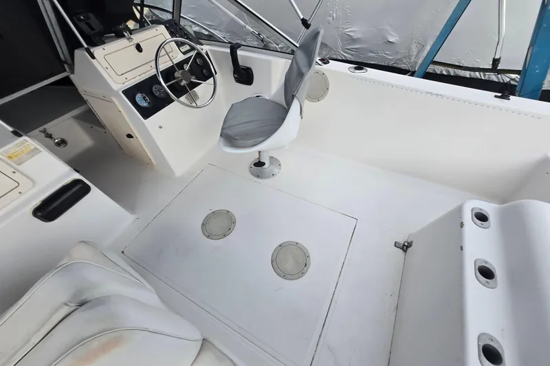 Slide: The Image of 1994 Sea Pro 190 Dual Console boat interior with steering wheel and seating. - 8