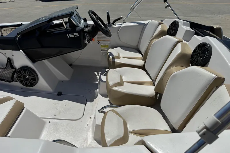 Slide: The Image of Interior of a 2017 Scarab 165 H.O. Platinum boat with beige and white seating. - 10