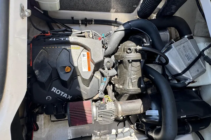 Slide: The Image of Engine compartment of a 2017 Scarab 165 H.O. Platinum boat featuring a Rotax 4-TEC engine. - 14