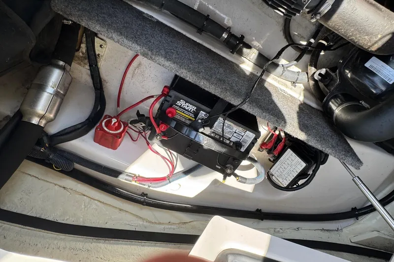 Slide: The Image of Engine compartment of a 2017 Scarab 165 H.O. Platinum boat with battery and wiring. - 15