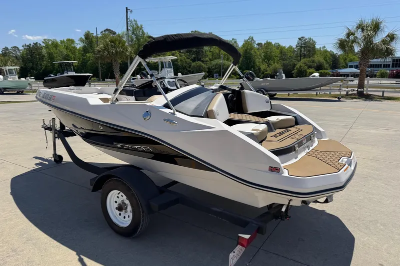 Slide: The Image of 2017 Scarab 165 H.O. Platinum boat on trailer, parked outdoors under clear sky. - 2