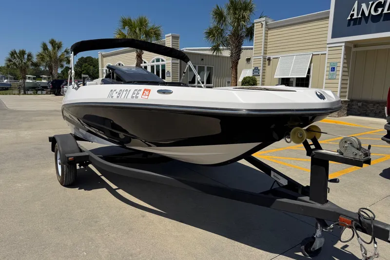 Slide: The Image of 2017 Scarab 165 H.O. Platinum boat on trailer, parked outside dealership on sunny day. - 3