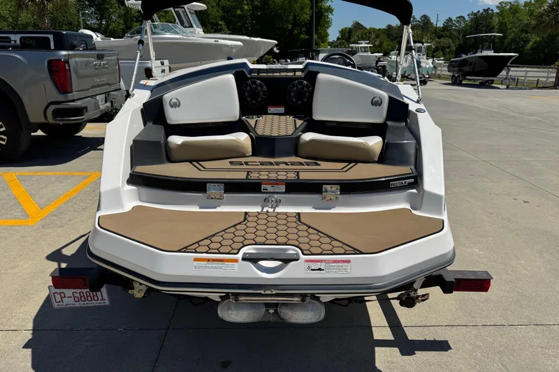 Slide: The Image of 2017 Scarab 165 H.O. Platinum boat on trailer, rear view in a parking lot. - 4