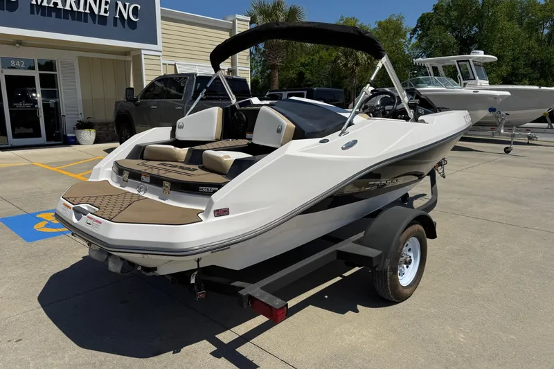 Slide: The Image of 2017 Scarab 165 H.O. Platinum boat on trailer outside marine dealership. - 5