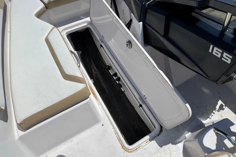 Slide: The Image of Open storage compartment on 2017 Scarab 165 H.O. Platinum boat deck. - 6