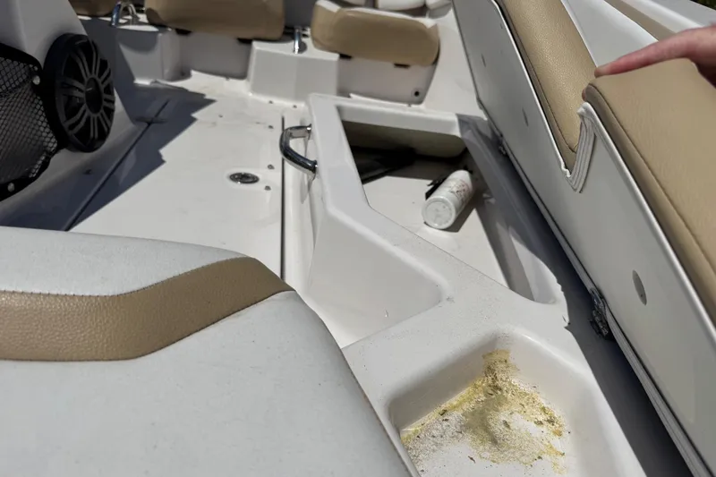 Slide: The Image of Interior of a 2017 Scarab 165 H.O. Platinum boat with beige seating and storage compartment. - 8