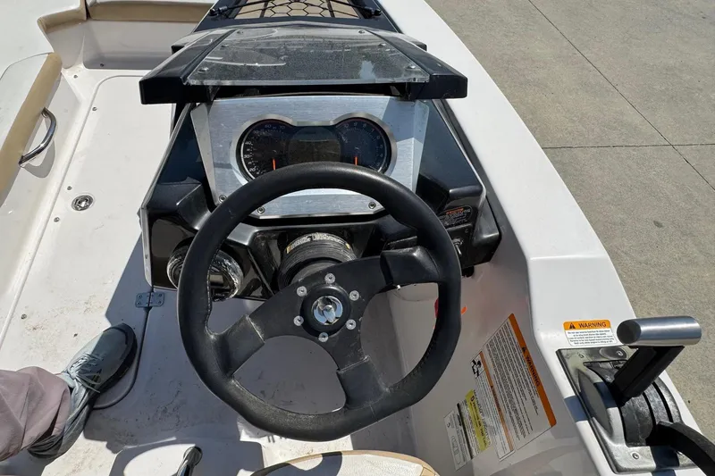 Slide: The Image of 2017 Scarab 165 H.O. Platinum boat dashboard with steering wheel and controls. - 9