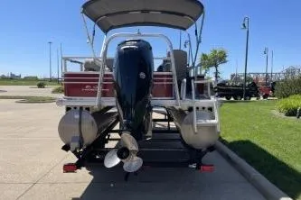 Slide: The Image of 2022 Sun Tracker Fishin' Barge 20 DLX pontoon boat, rear view, parked outdoors. - 10