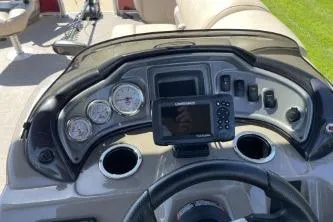 Slide: The Image of 2022 Sun Tracker Fishin' Barge 20 DLX dashboard with gauges and navigation system. - 3