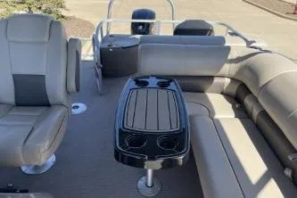 Slide: The Image of 2022 Sun Tracker Fishin' Barge 20 DLX interior with seating and table. - 4
