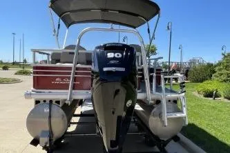 Slide: The Image of 2022 Sun Tracker Fishin' Barge 20 DLX pontoon boat with 90 HP engine, docked outdoors. - 8