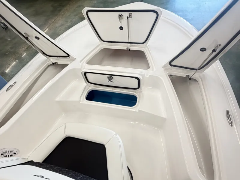 Slide: The Image of Interior view of 2026 Tidewater 2110 Bay Max boat with open storage compartments. - 14