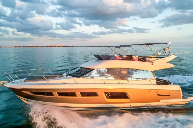 The Image of Luxury 2013 Prestige 500 yacht cruising on open water at sunset. - 0