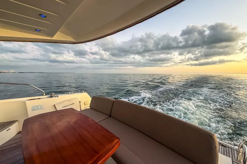 Slide: The Image of Prestige 500 yacht cruising at sunset, 2013 model, with ocean view and seating area. - 14