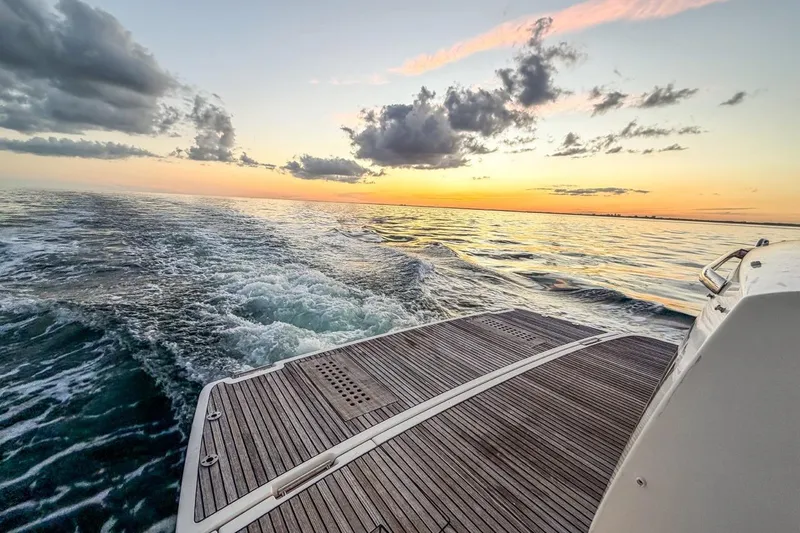 Slide: The Image of Sunset view from a 2013 Prestige 500 yacht, cruising on calm waters. - 16